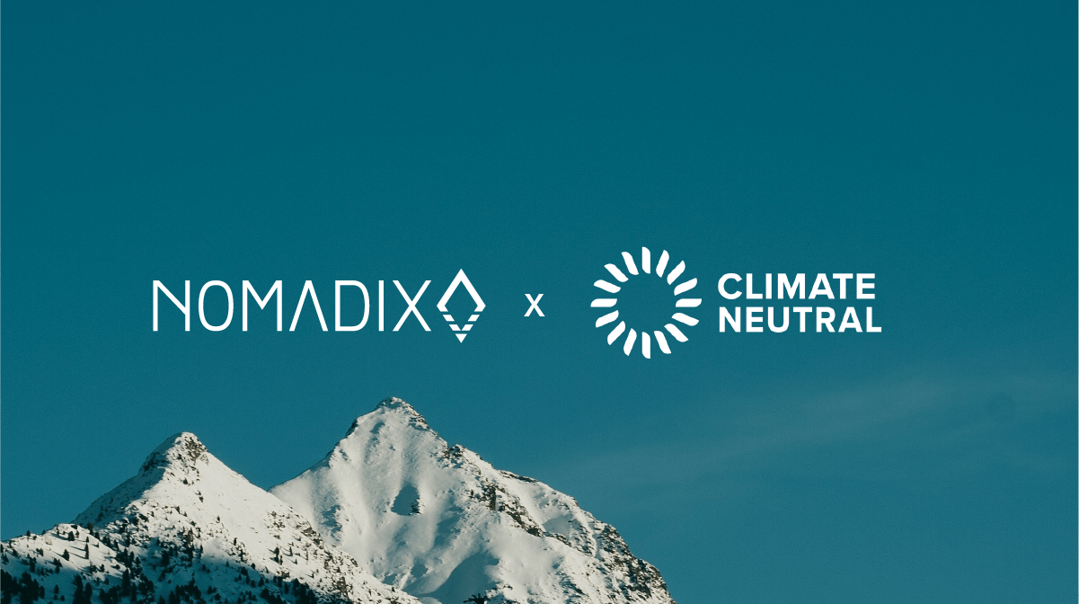 Nomadix and Climate Neutral logos over a snowy mountain landscape