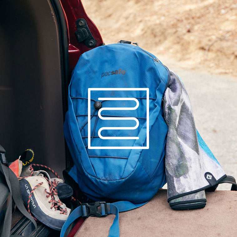 Running gear, including a backpack with a Nomadix towel sticking out of it.