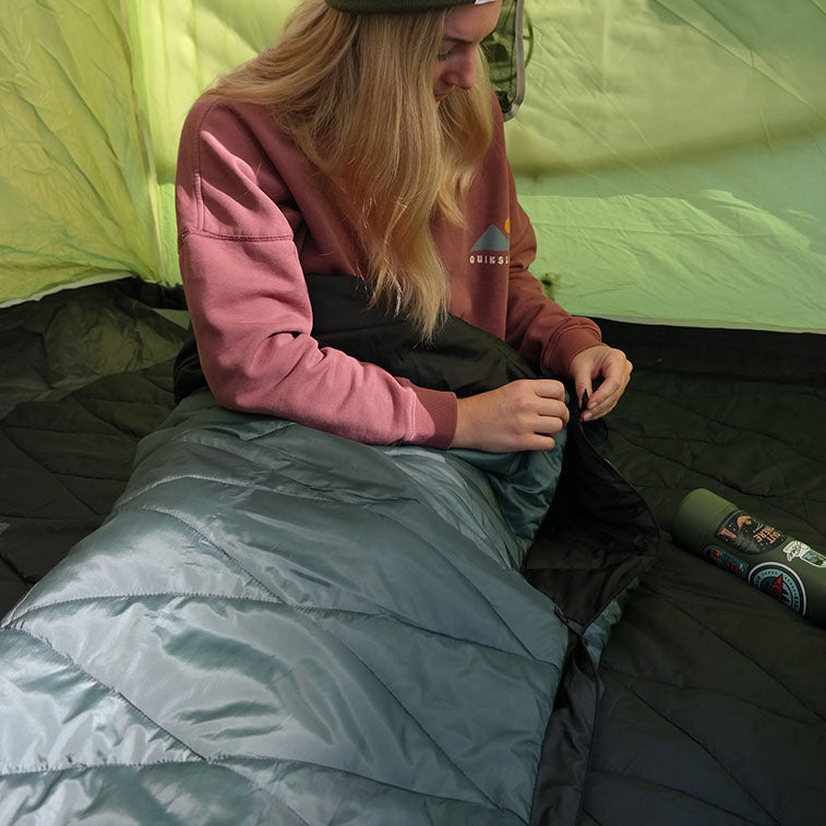 a woman sitting on a bed