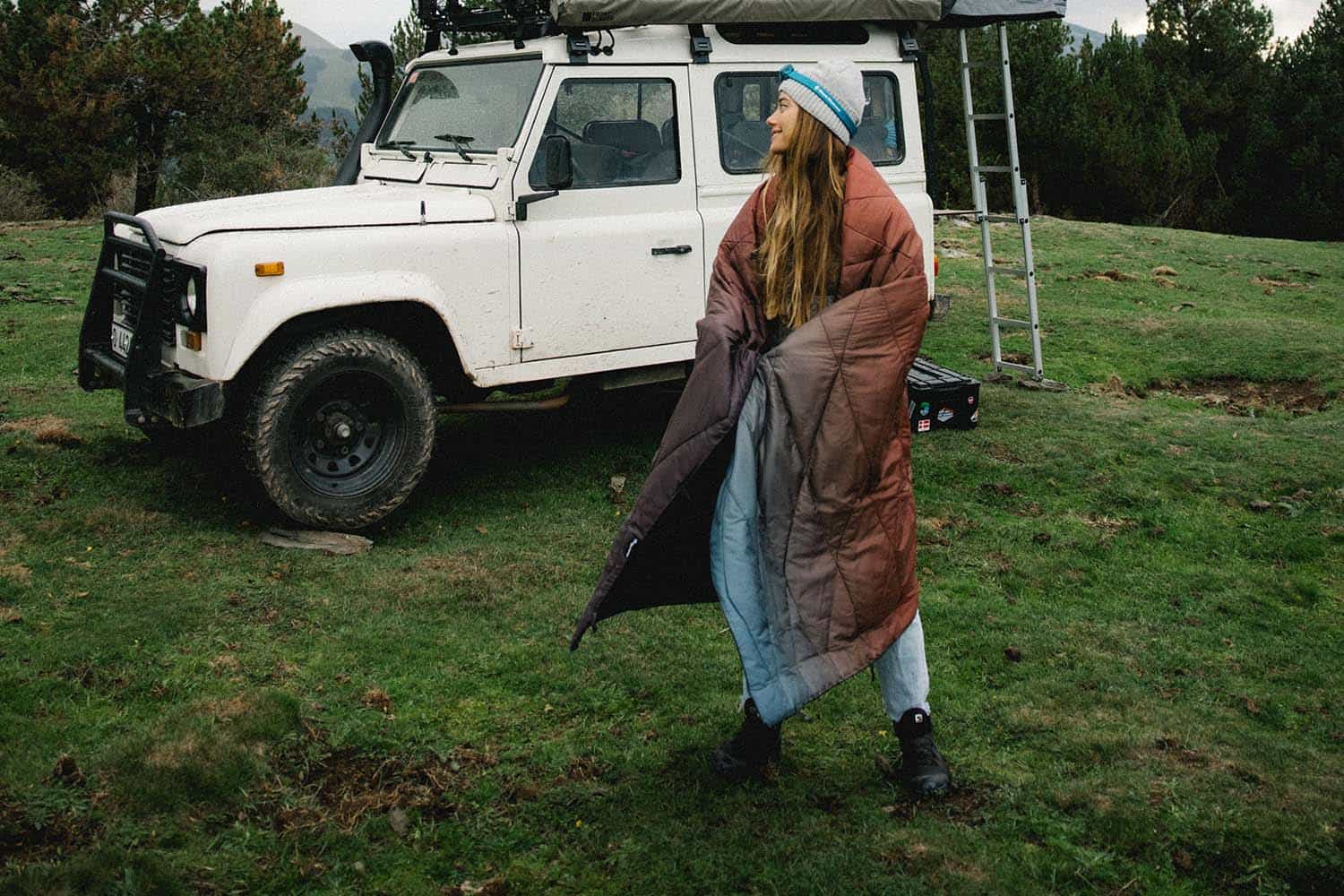 a person in a garment next to a white truck